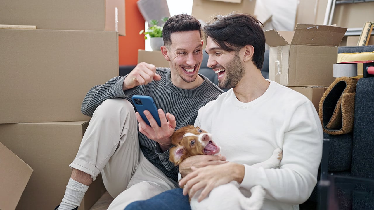 home owners sitting amongst moving boxes