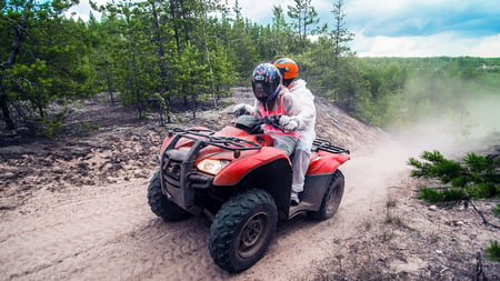 Two people on a quad. 
