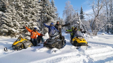 A group of friends snowmobiling