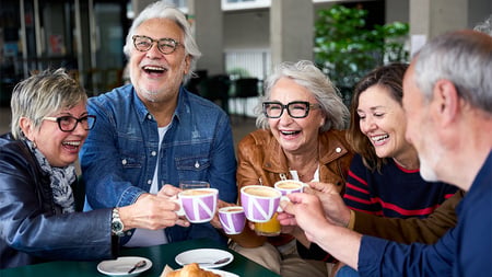 Five people gathered around a table. 