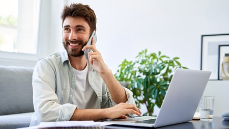 A smiling man on the phone