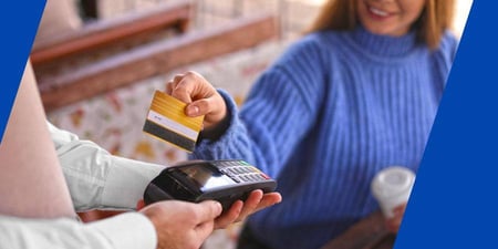 A woman pays for her purchase with a card 