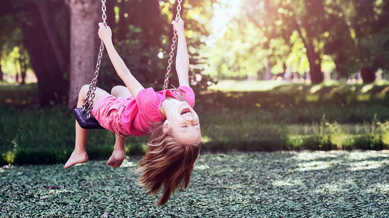 Smiling child on a swing. 