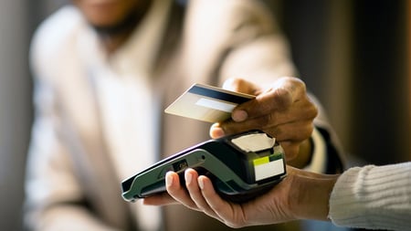 A customer tapping their card on a card machine. 
