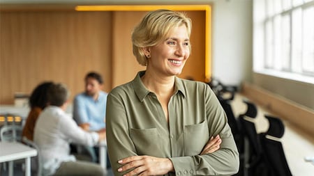 A smiling women with her arms folded